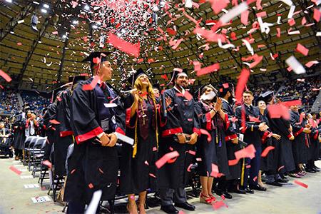 UIW students celebrating commencement with confetti